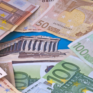 euro crisis in Greek with euro bank notes and the Akropolis building