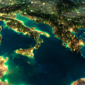 Highly detailed Earth illuminated by moonlight. The glow of cities sheds light on the detailed exaggerated terrain. A piece of Europe - Italy and Greece. Elements of this image furnished by NASA